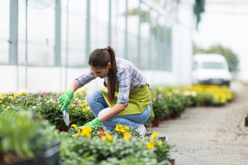 Gardener reviewing a service concern in a garden setting
